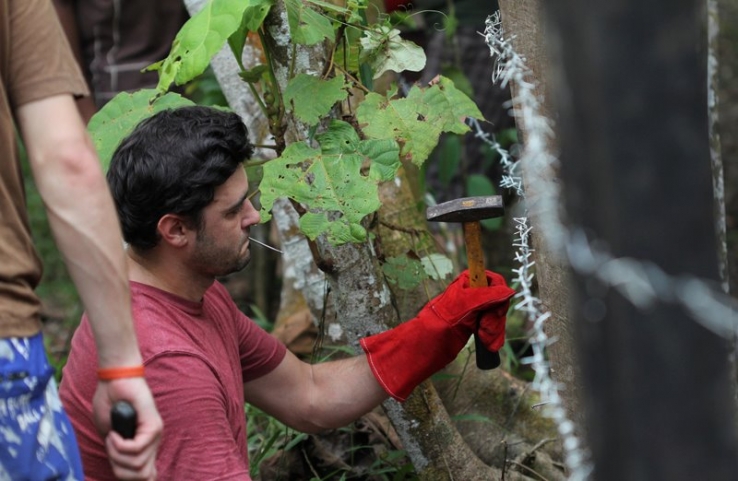 Fabrice Marre helping to upgrade the fence